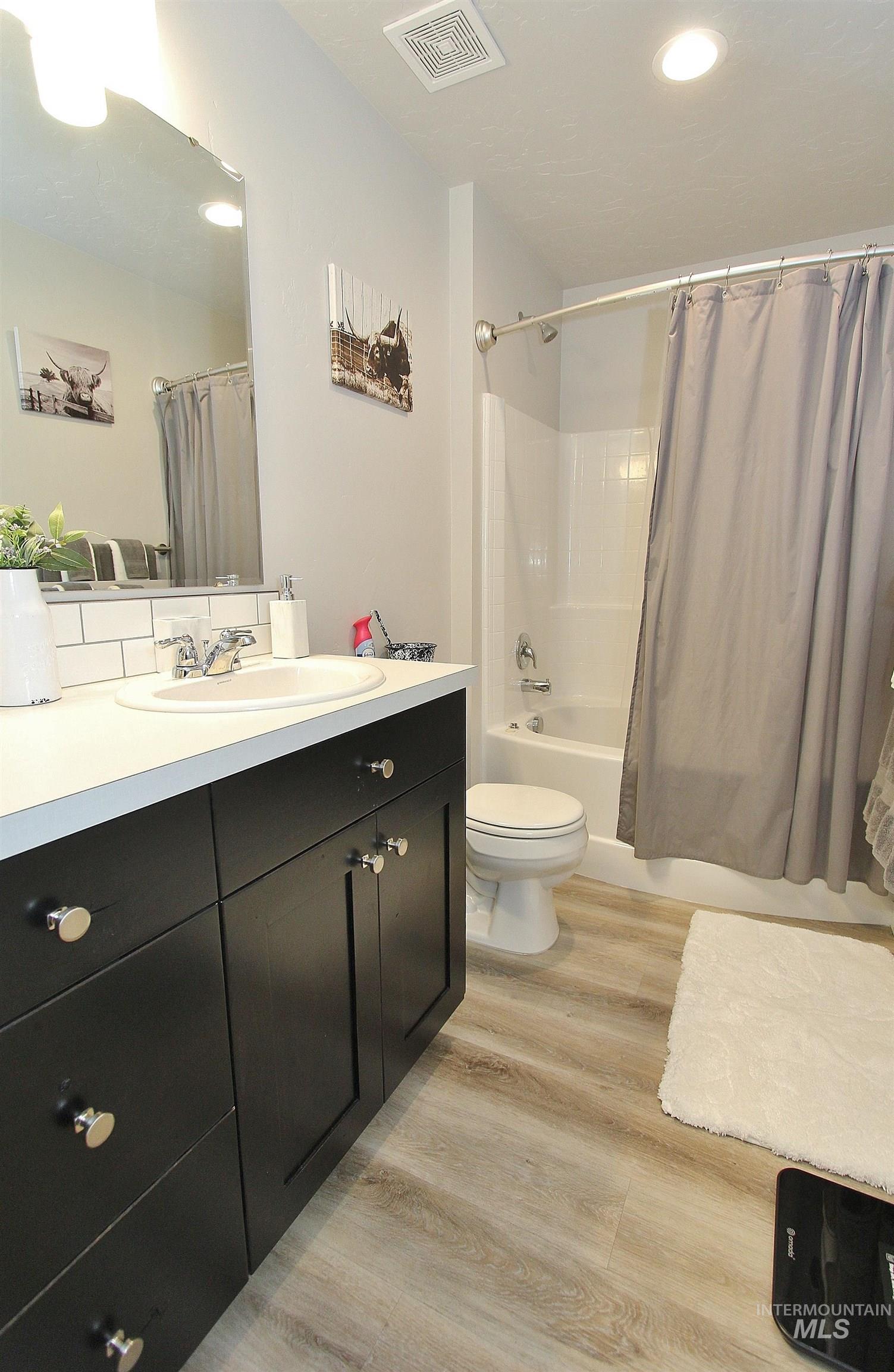 1211 Mahogany Street Parma, ID 83660 - Photo 16 of 22 Full bathroom with vanity, shower / bath combo, light wood finished floors, and recessed lighting