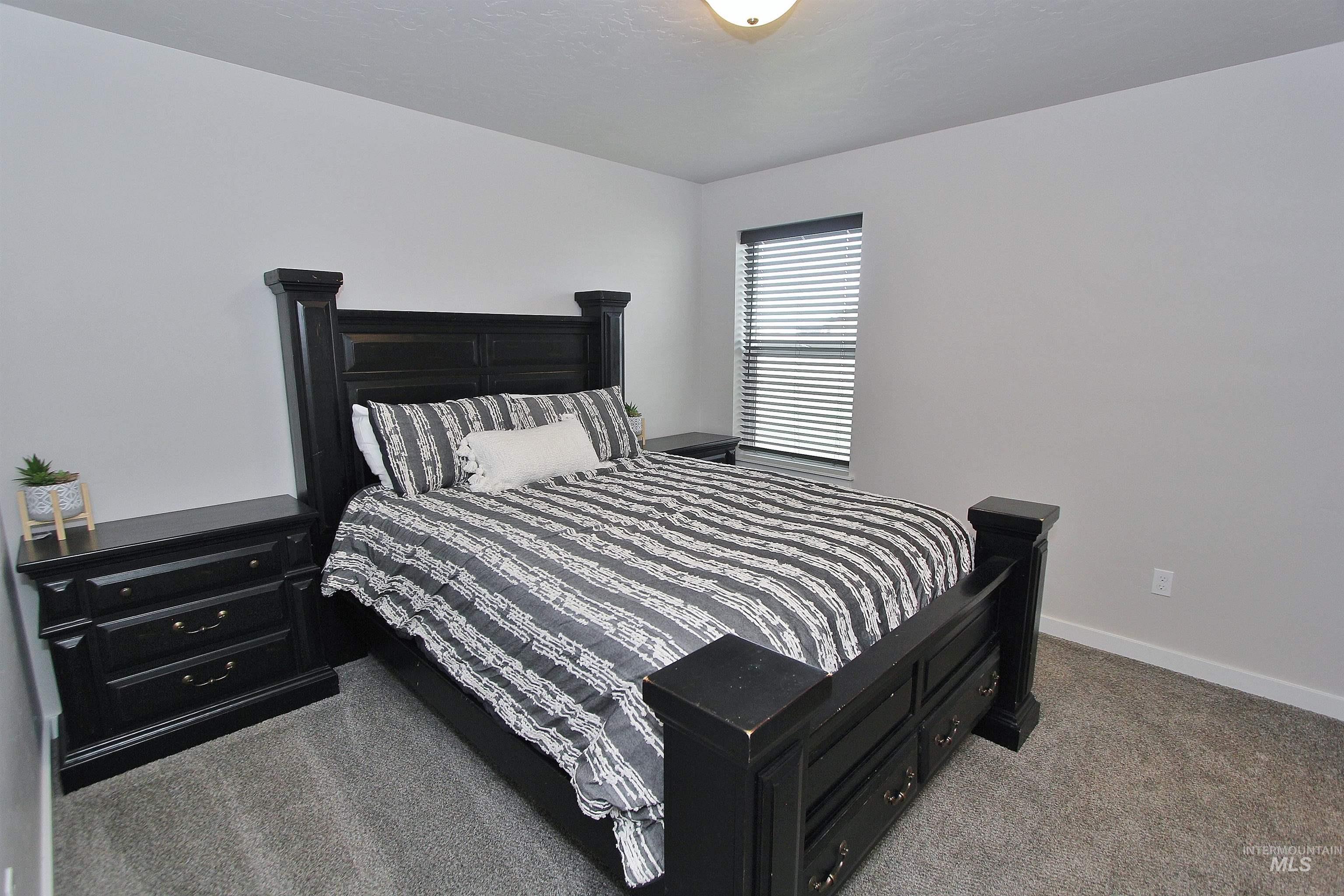 1211 Mahogany Street Parma, ID 83660 - Photo 17 of 22 Bedroom featuring light carpet and baseboards