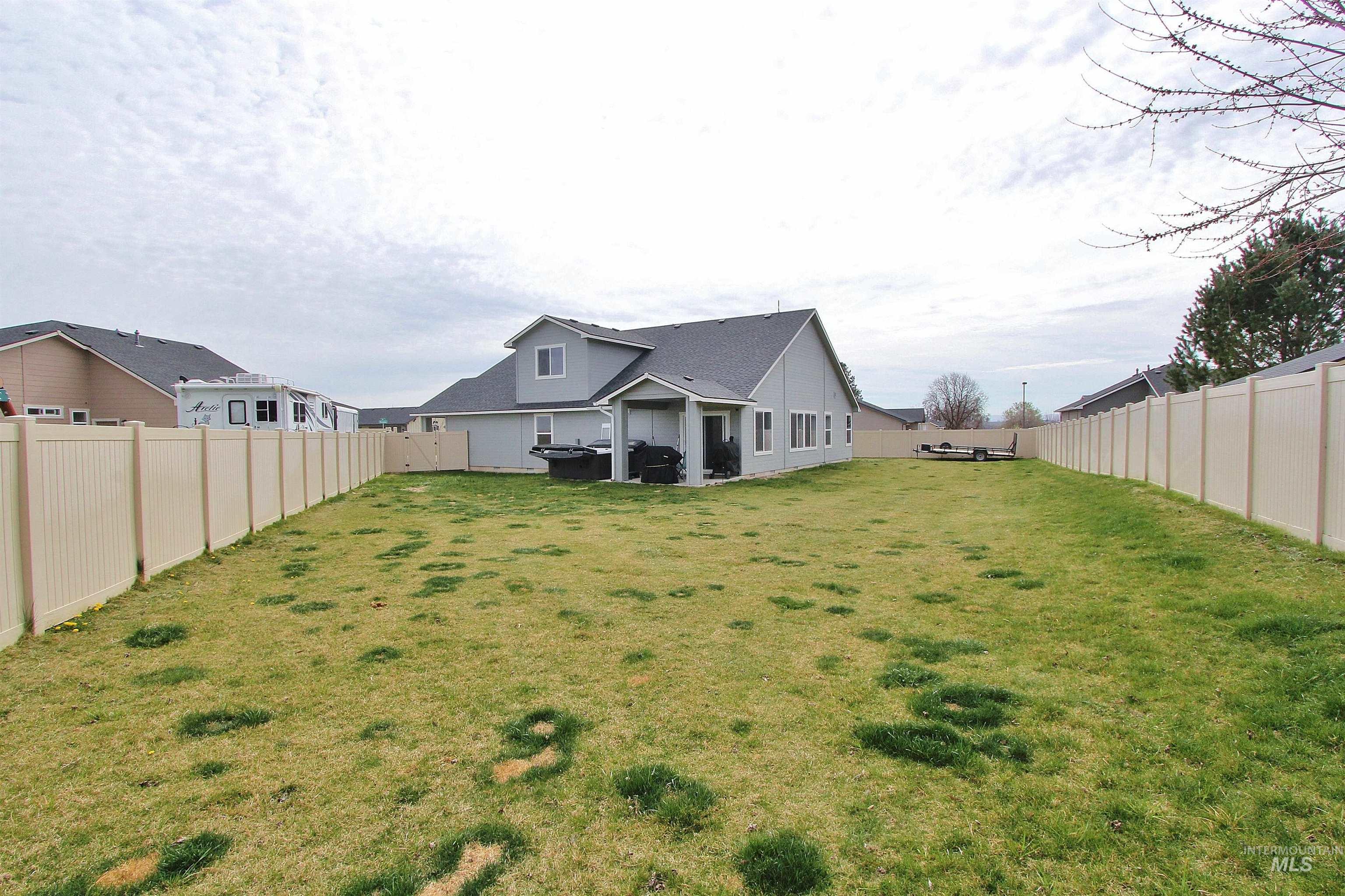 1211 Mahogany Street Parma, ID 83660 - Photo 20 of 22 Rear view of property with a patio area and a fenced backyard
