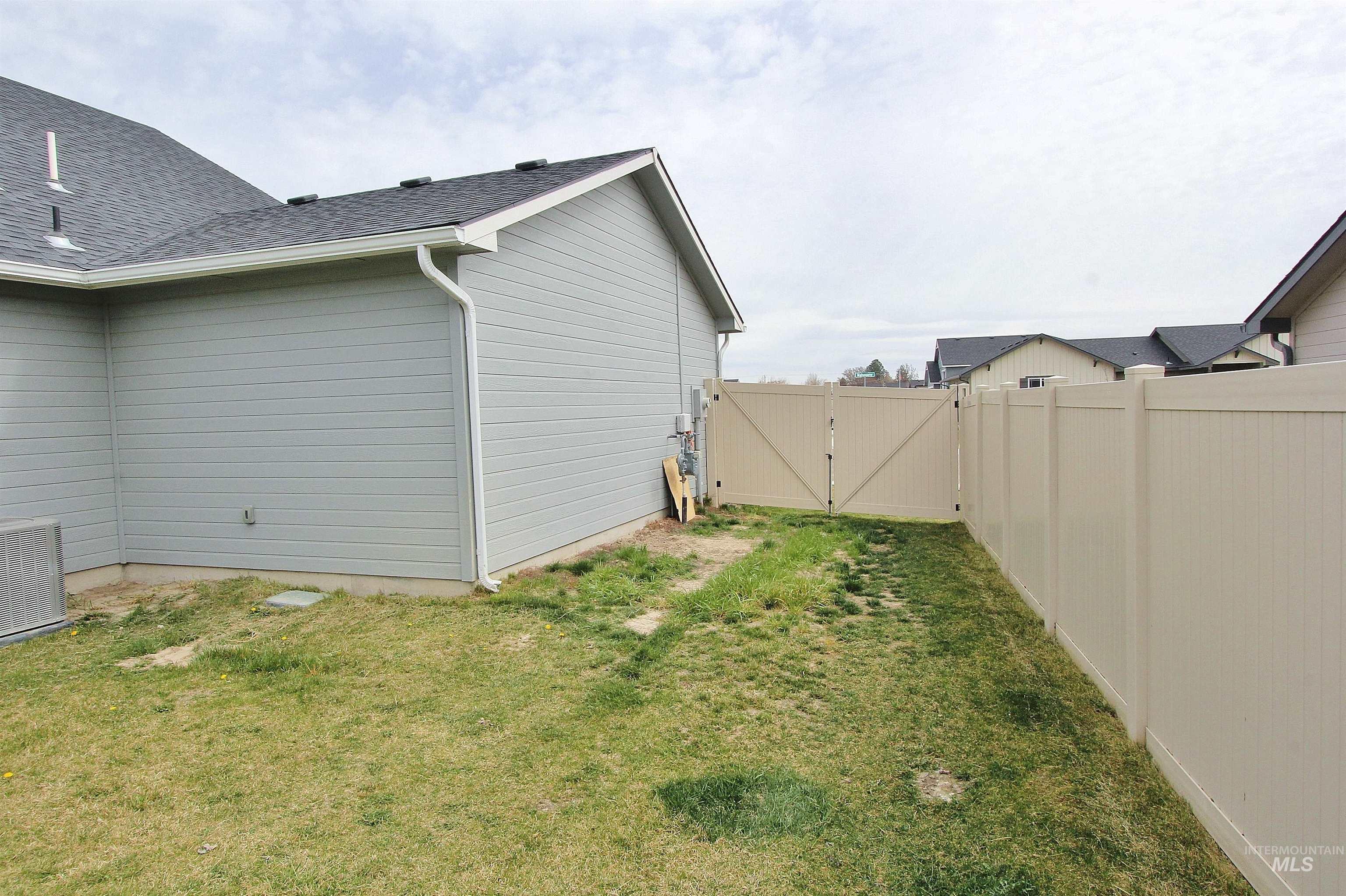 1211 Mahogany Street Parma, ID 83660 - Photo 22 of 22 View of side of home with a gate, a fenced backyard, and roof with shingles