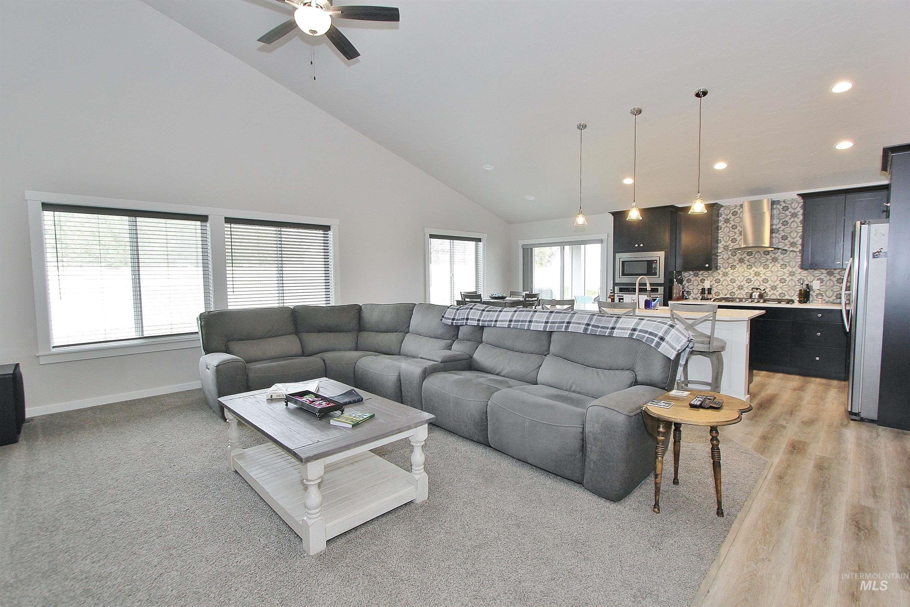 1211 Mahogany Street Parma, ID 83660 - Photo 3 of 22 Living area with lofted ceiling, a ceiling fan, recessed lighting, and light wood-type flooring