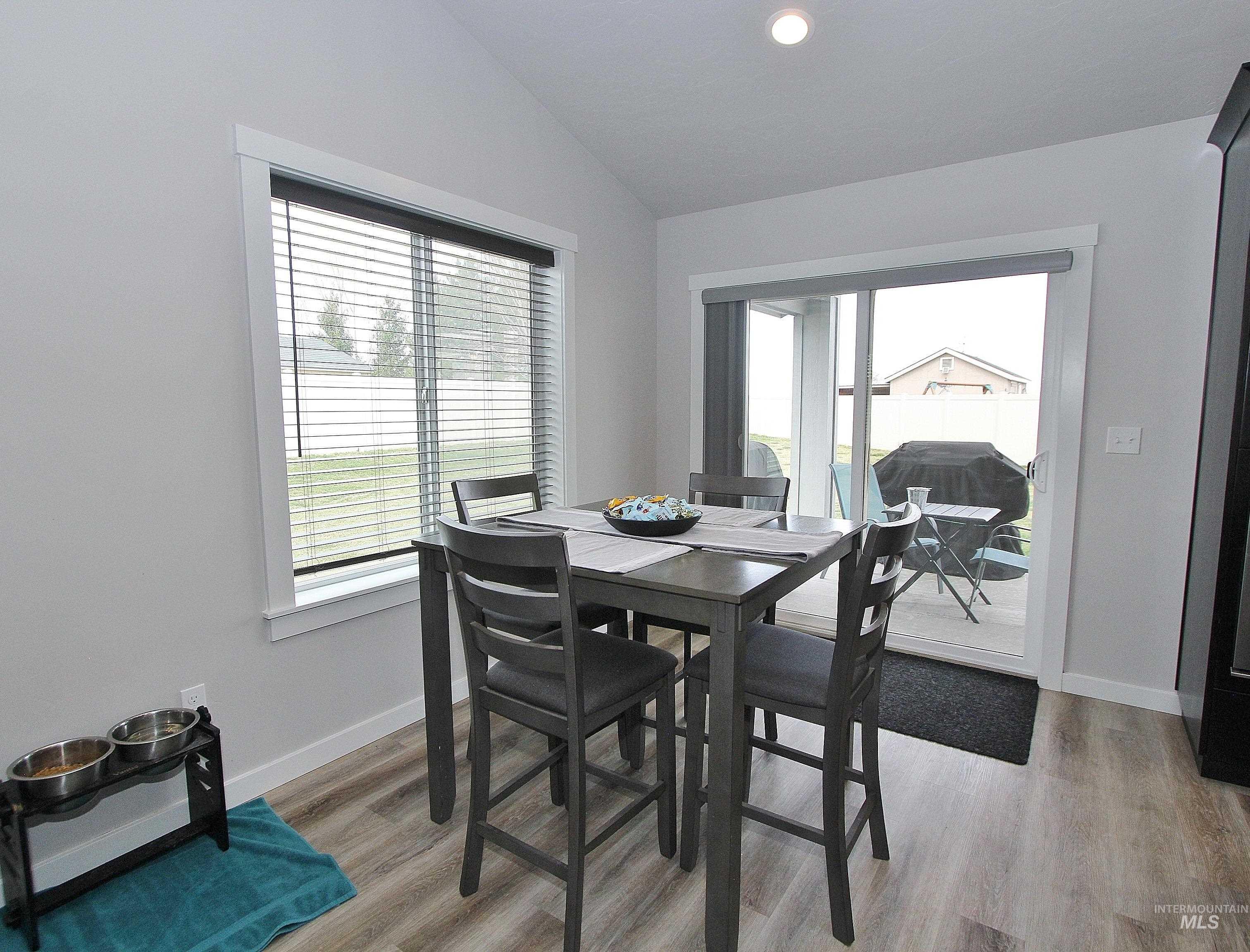 1211 Mahogany Street Parma, ID 83660 - Photo 8 of 22 Dining space featuring light wood-style floors, vaulted ceiling, plenty of natural light, and recessed lighting