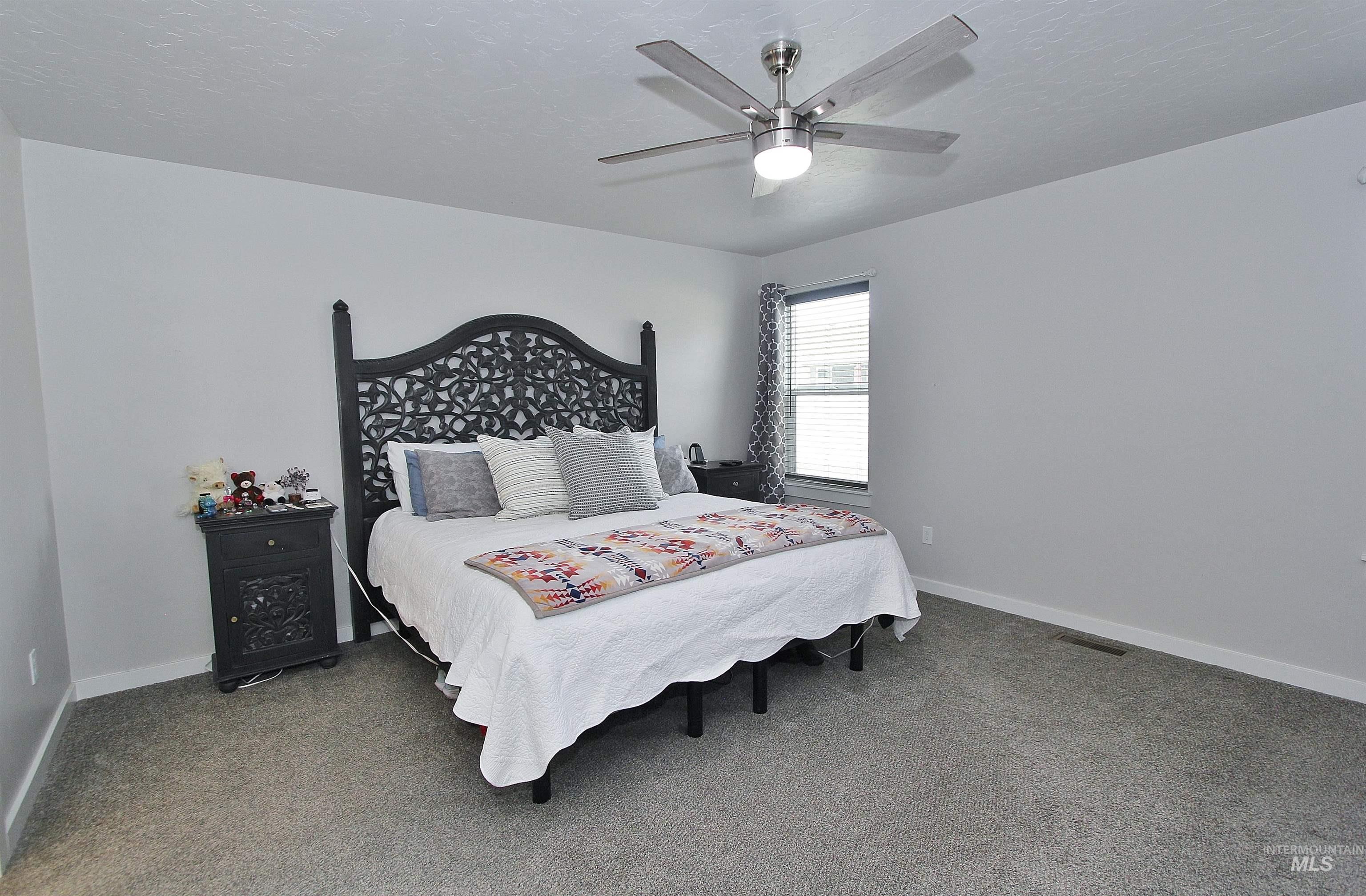 1211 Mahogany Street Parma, ID 83660 - Photo 9 of 22 Bedroom with carpet floors, a ceiling fan, and a textured ceiling