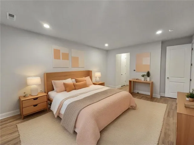 a bedroom with bed and a couch