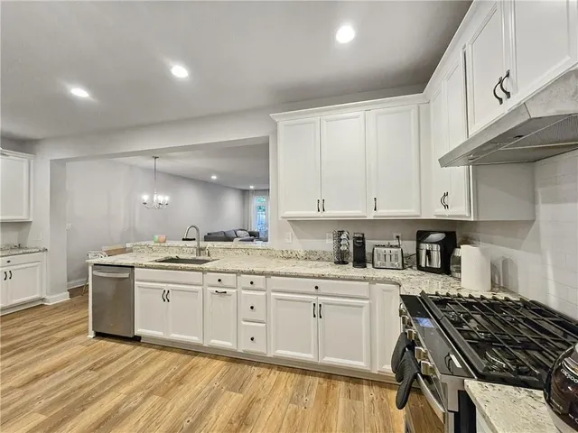 a kitchen with a sink stove and cabinets