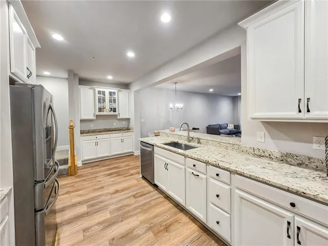 a large kitchen with kitchen island a sink stainless steel appliances and cabinets