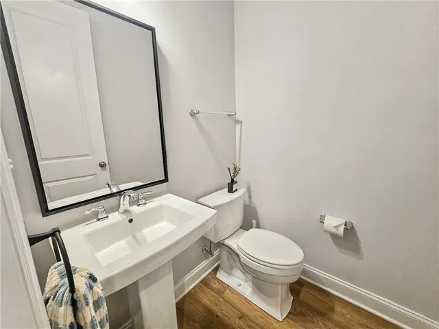 a bathroom with a sink a toilet and mirror