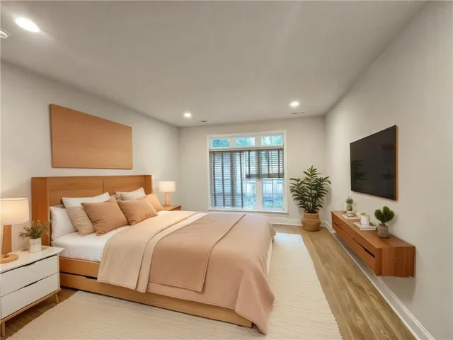 a spacious bedroom with a large bed and a flat screen tv