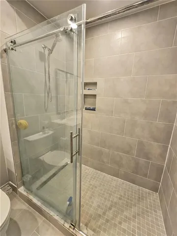 a bathroom with a glass door shower