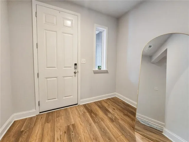 a view of a room with wooden floor and bathroom