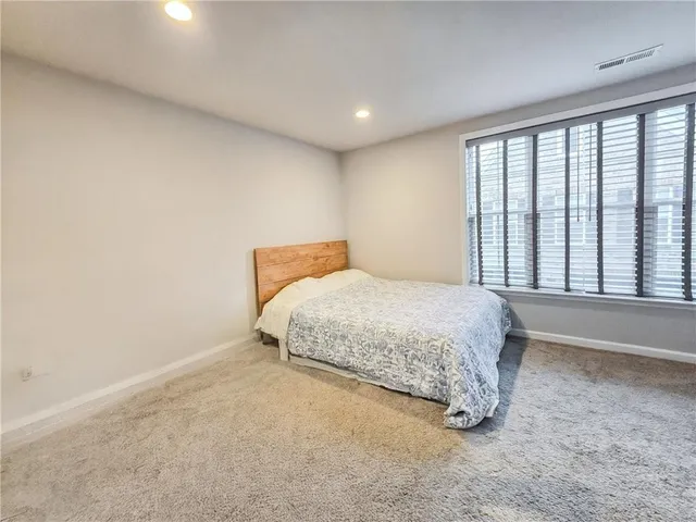 a bed sitting in a room next to a window