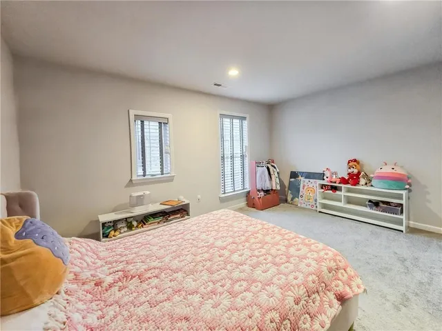 a bedroom with furniture and a window