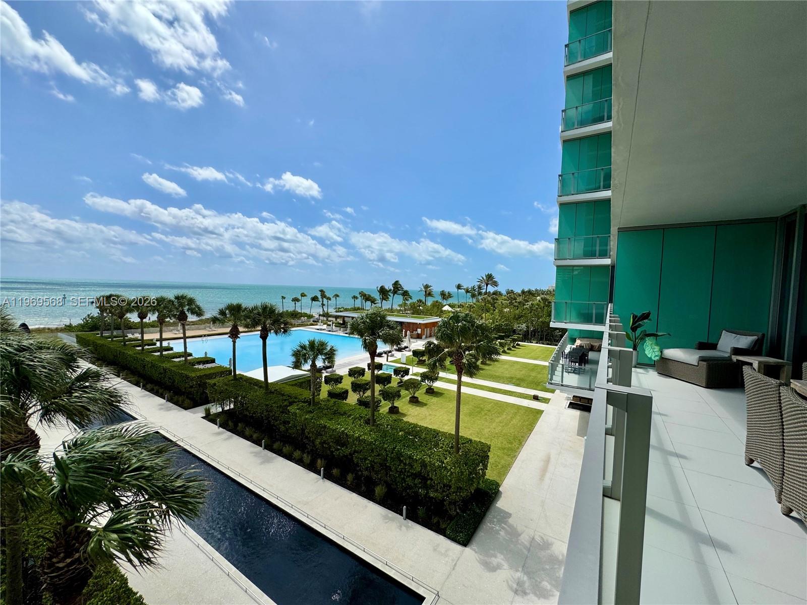 350 Ocean Drive, Unit 406N Key Biscayne, FL 33149 - Photo 3 of 41 a view of a swimming pool with a yard
