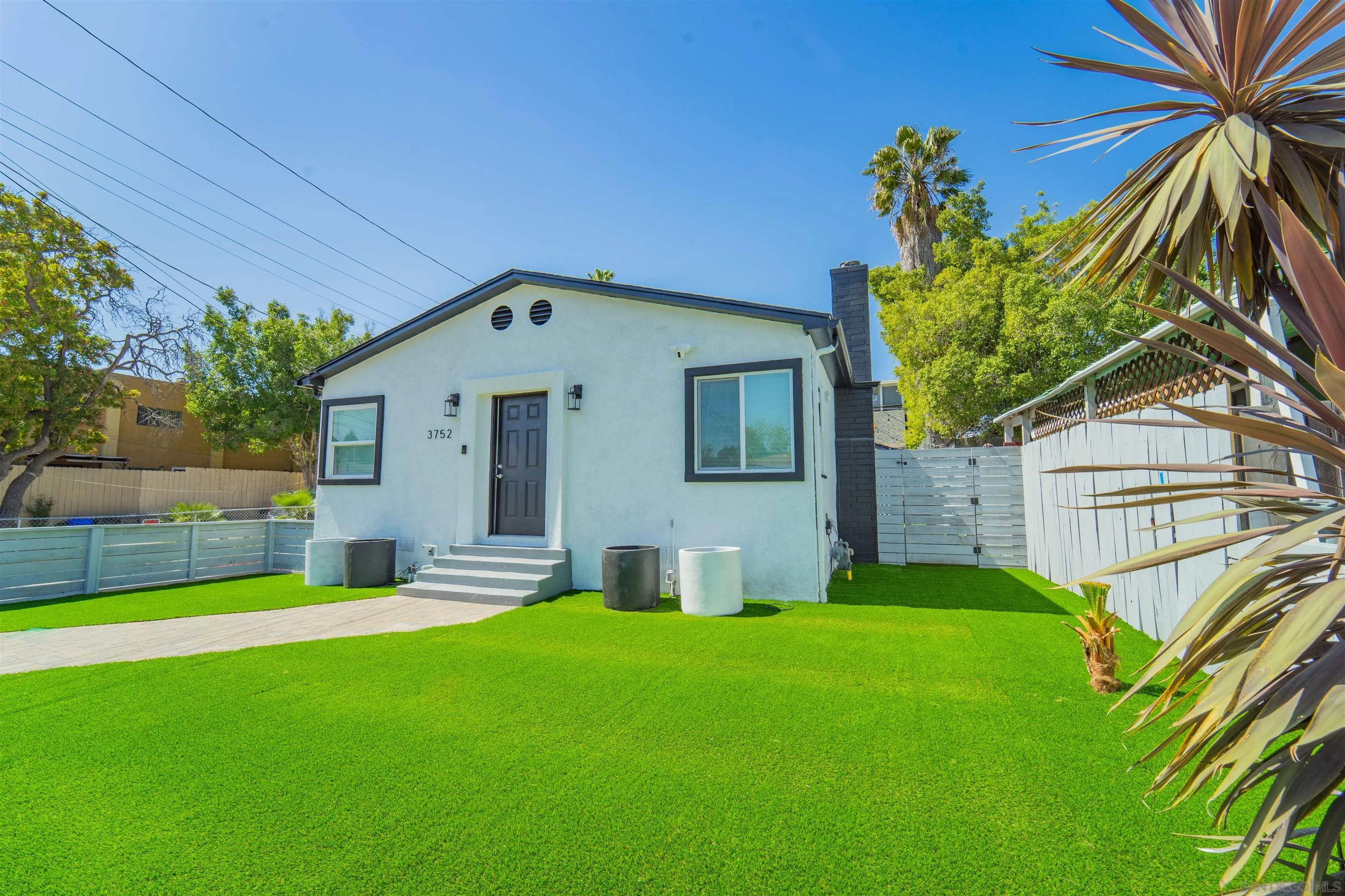3752 Harris Street La Mesa, CA 91941 - Photo 1 of 24 a front view of a house with a yard