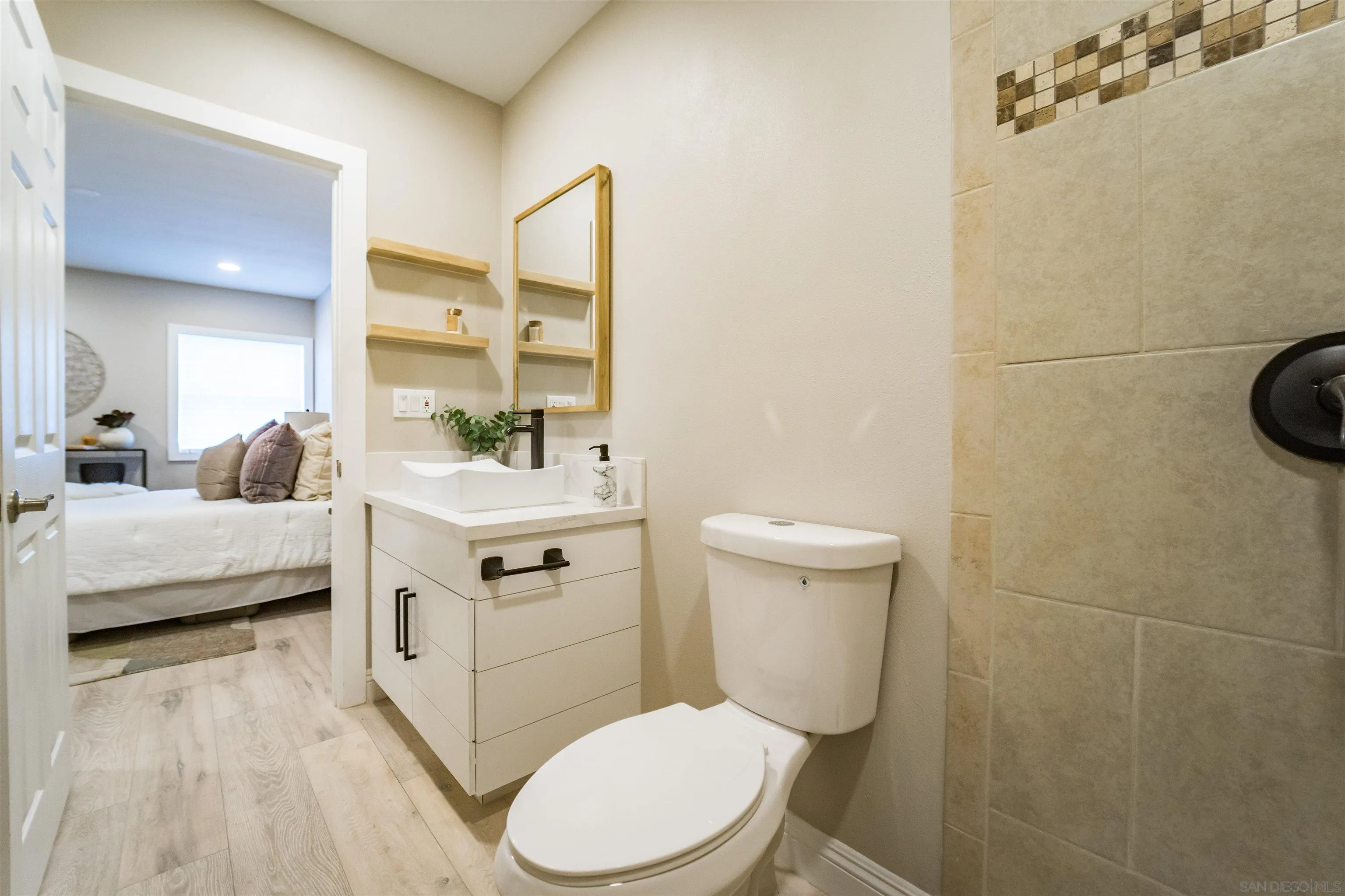 3752 Harris Street La Mesa, CA 91941 - Photo 20 of 24 a bathroom with a sink a toilet and mirror
