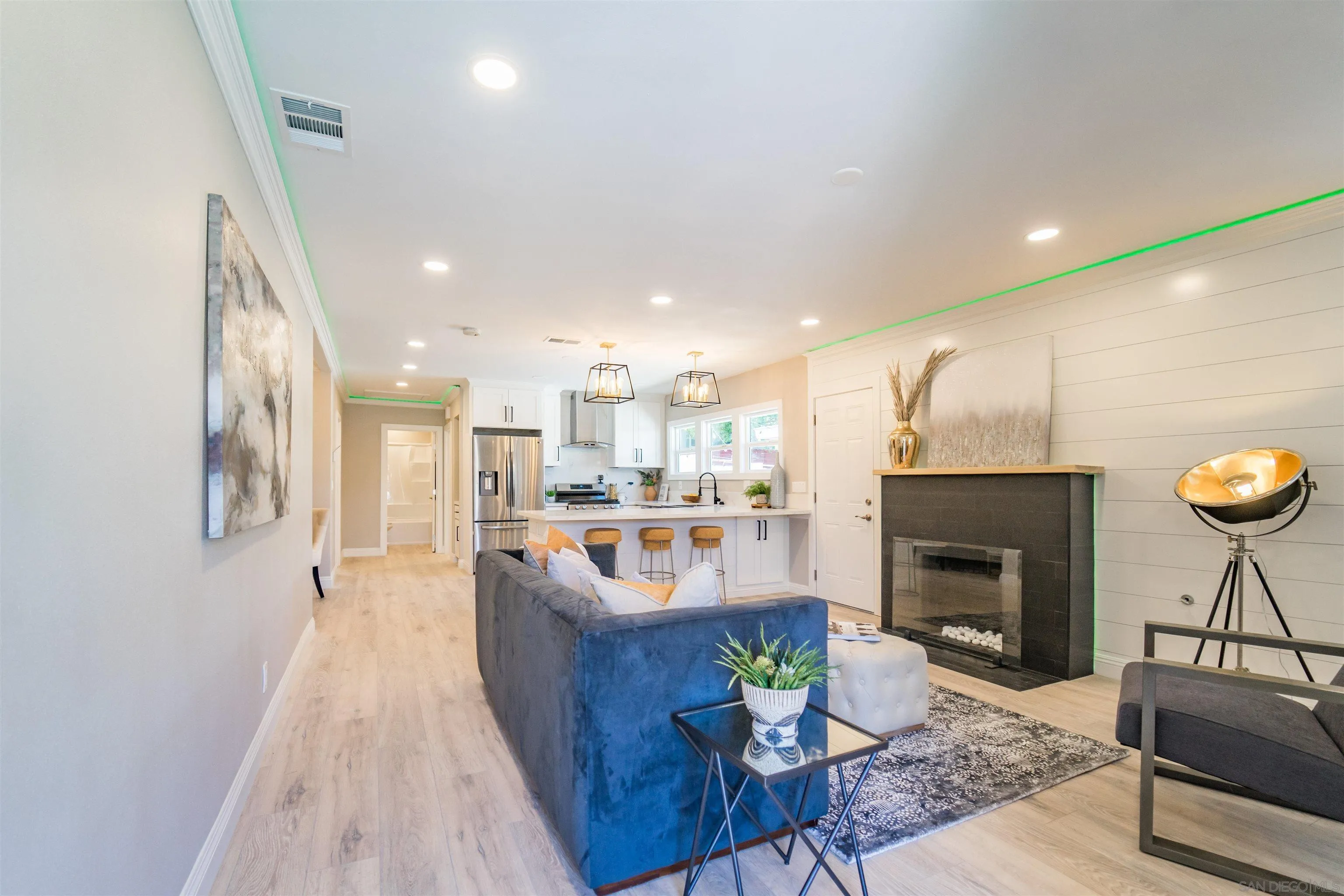 3752 Harris Street La Mesa, CA 91941 - Photo 9 of 24 a living room with stainless steel appliances furniture a rug and a kitchen view