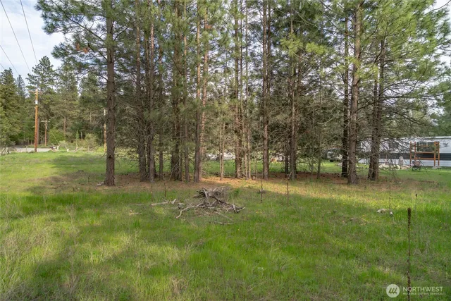 an aerial view of a house with trees in the background