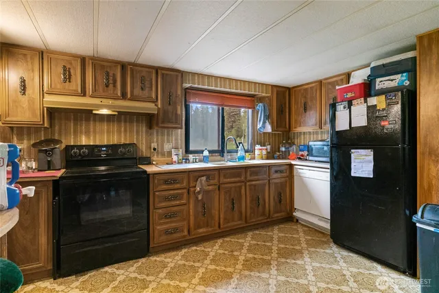 a kitchen with stainless steel appliances granite countertop a stove and a refrigerator