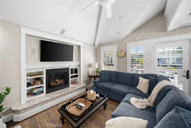 a kitchen with granite countertop a table chairs microwave and cabinets