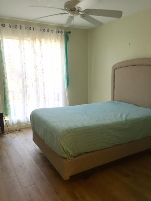 480 Kenolio Road, Unit 26105 Kihei, HI 96753 - Photo 12 of 16 a bedroom with a bed and a window