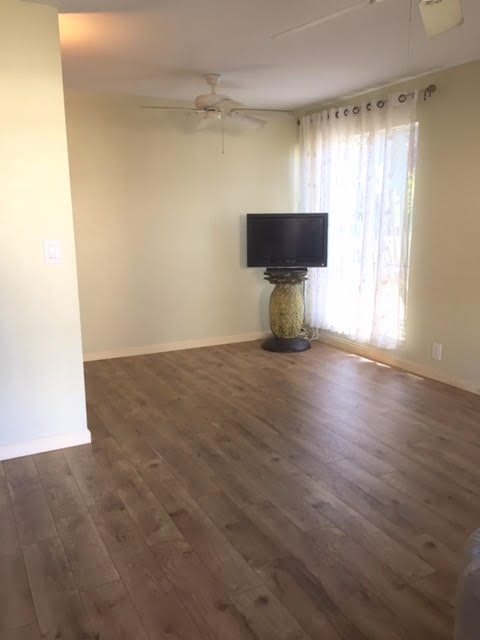 480 Kenolio Road, Unit 26105 Kihei, HI 96753 - Photo 5 of 16 an empty room with wooden floor and windows