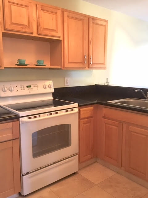 480 Kenolio Road, Unit 26105 Kihei, HI 96753 - Photo 7 of 16 a kitchen with granite countertop cabinets stainless steel appliances and a counter space