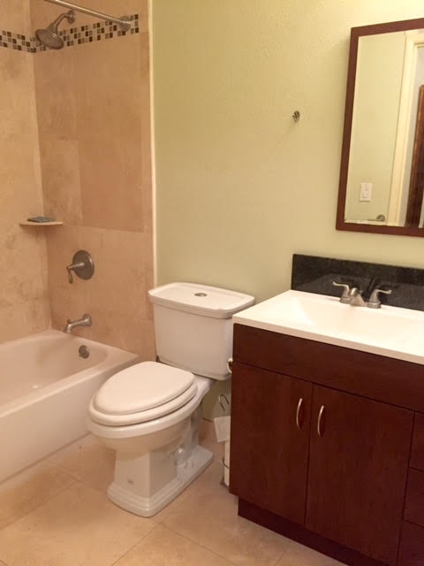 480 Kenolio Road, Unit 26105 Kihei, HI 96753 - Photo 8 of 16 a bathroom with a sink a toilet and shower