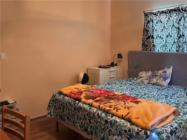 a bedroom with a bed and dresser