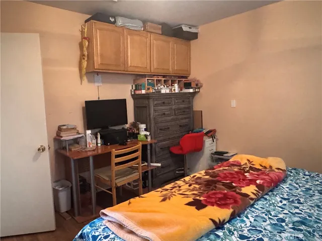 a bedroom with a bed and a desk