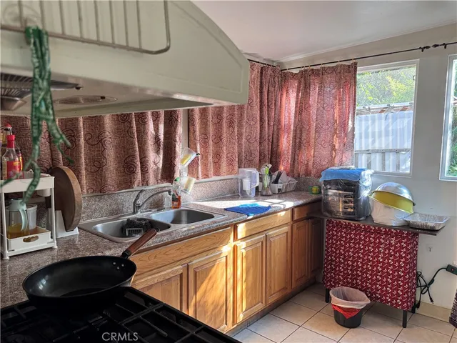 a kitchen with a sink and a stove top oven