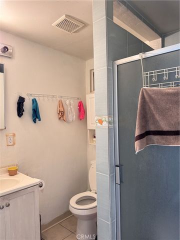 a bathroom with a sink a toilet and a shower