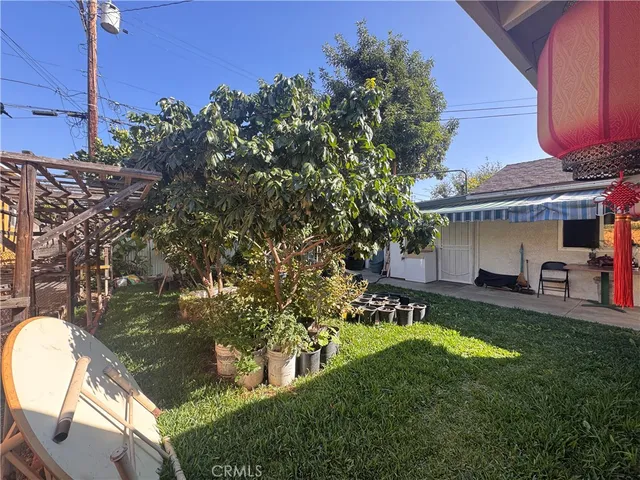 a view of a house with a yard balcony and sitting area