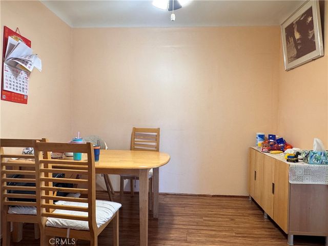 a view of a room with wooden floor and furniture