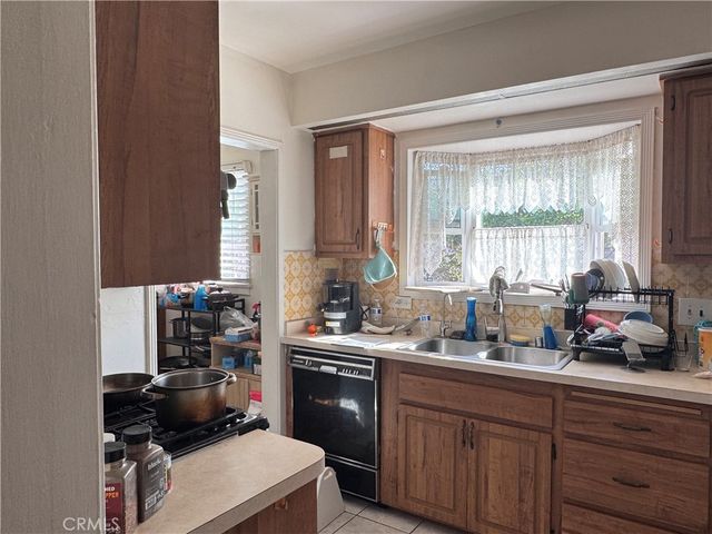 a kitchen with a sink stove and window
