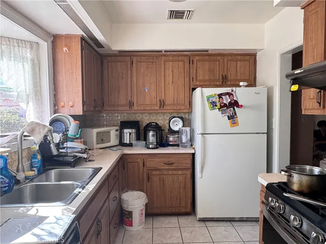 a kitchen with a refrigerator sink and stove
