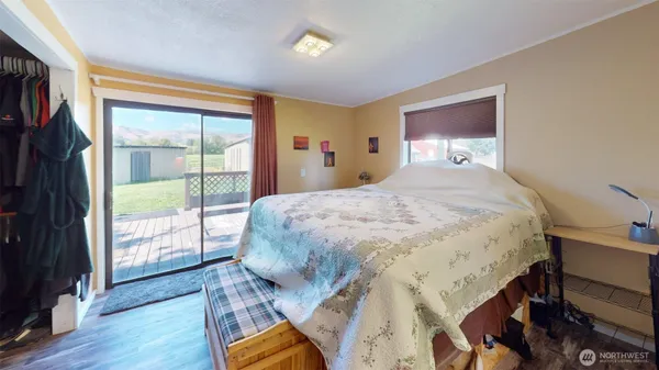 a bedroom with a bed and a large window