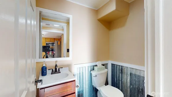 a bathroom with a toilet sink and mirror