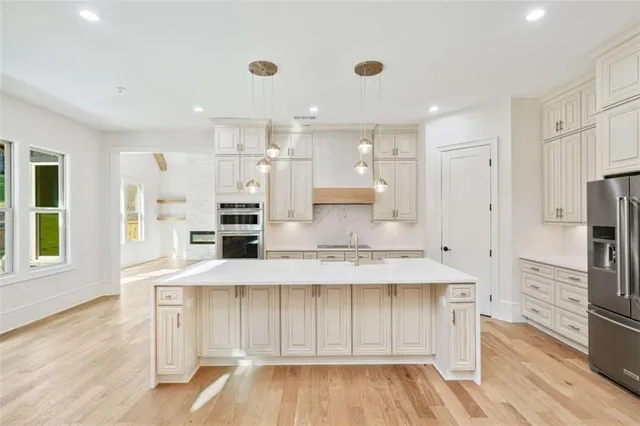 a view of a hallway with wooden floor and a fireplace