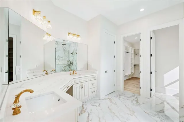 a view of an empty walk in closet with wooden floor
