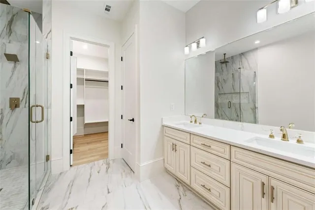 an empty room with wooden floor chandelier fan and windows