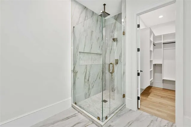 a view of a room with wooden floor and a ceiling fan