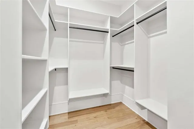 a bathroom with a toilet a sink a mirror a bathtub and vanity