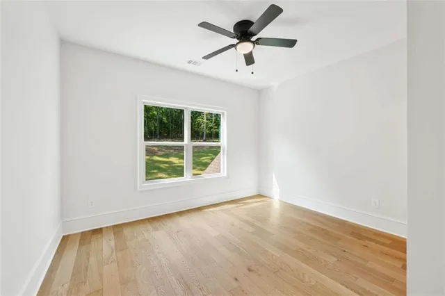 a view of a room with wooden floor