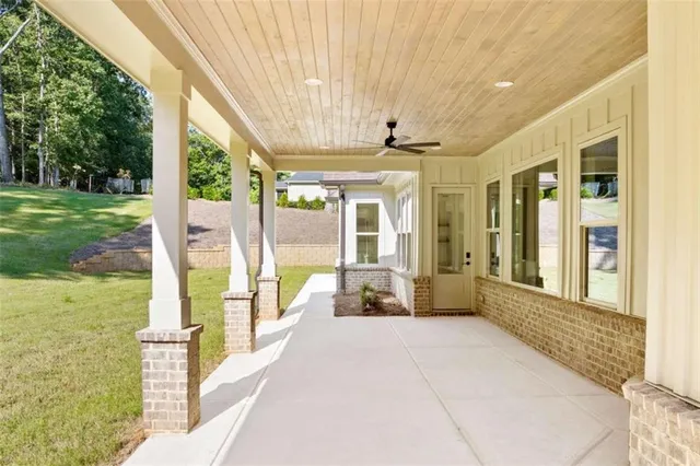 a view of a house with a yard and sitting area