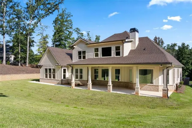 an aerial view of a house with a yard and large trees