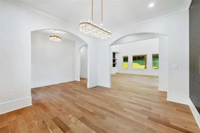 a view of an empty room with a fireplace and a window
