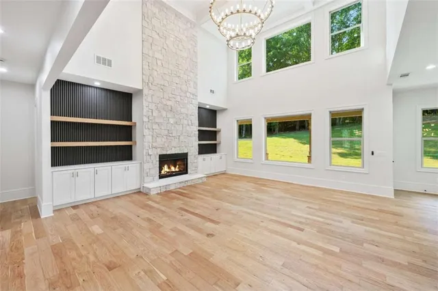 a view of entryway with kitchen and hall with wooden floor