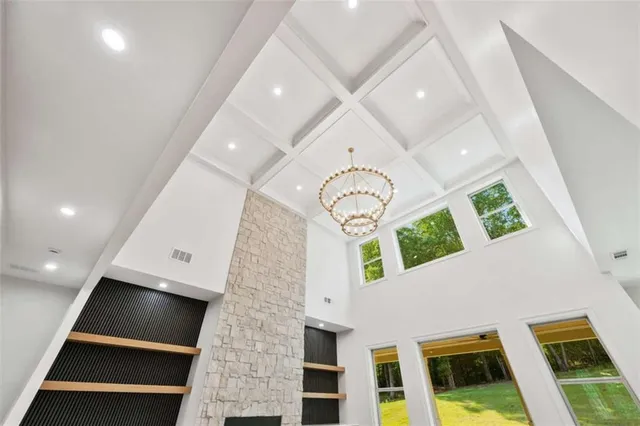 a view of an empty room with a fireplace and a window