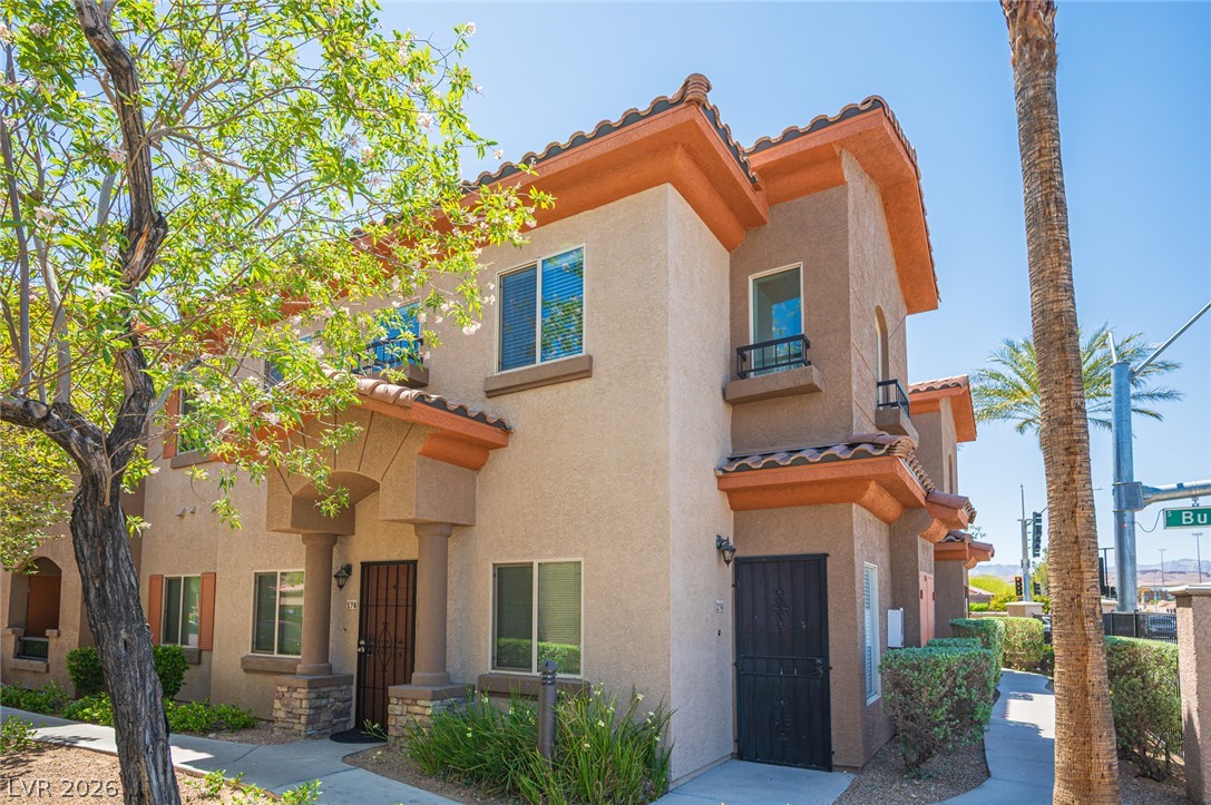 7701 West Robindale Road, Unit 274 Las Vegas, NV 89113 - Photo 1 of 43 A Mediterranean-inspired townhouse with tile roof accents and lush green landscaping welcomes residents.