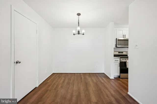 a view of a room with wooden floor and stairs